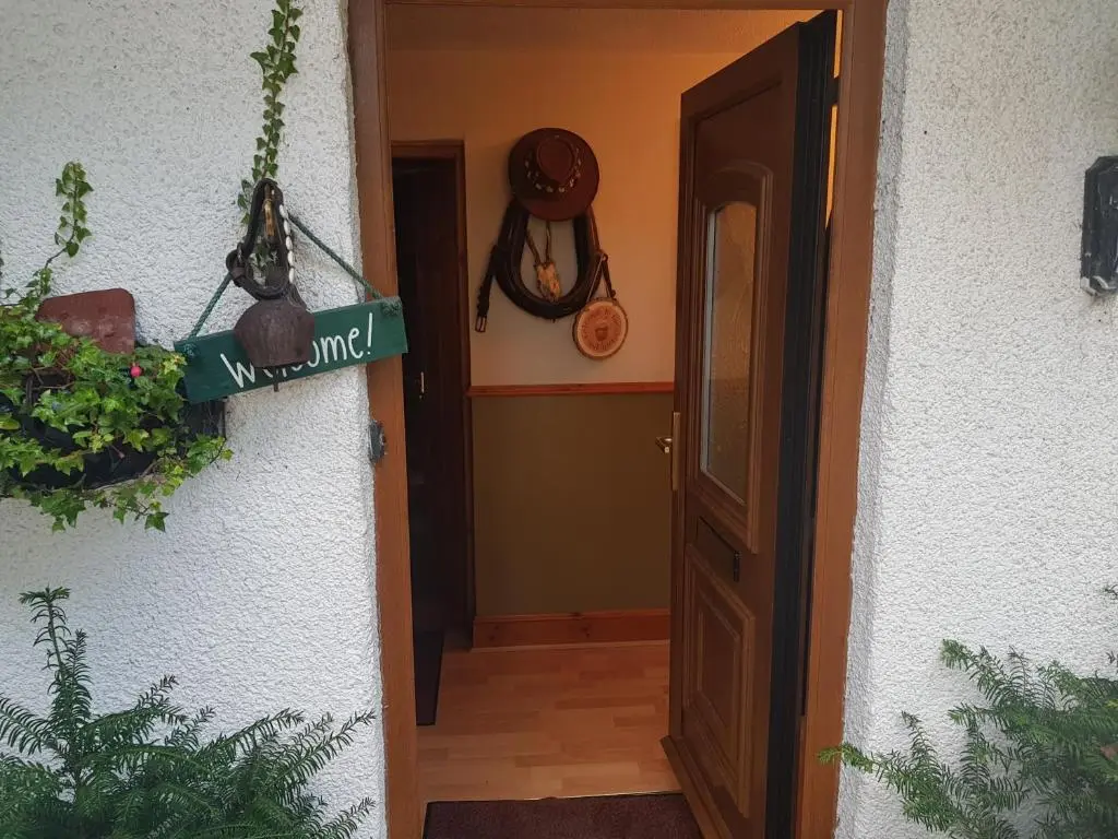 a hallway with a door and a sign that says wayfinding at Hosefield Bed and Breakfast in Ellon