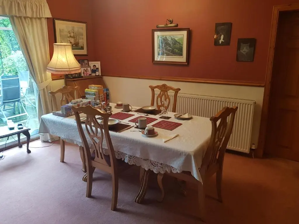 a dining room with a table and chairs at Hosefield Bed and Breakfast in Ellon