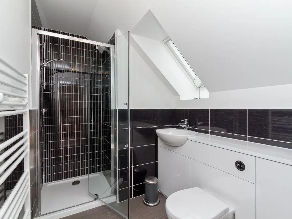 a bathroom with a shower and a toilet and a sink at Birch Corner in Aviemore
