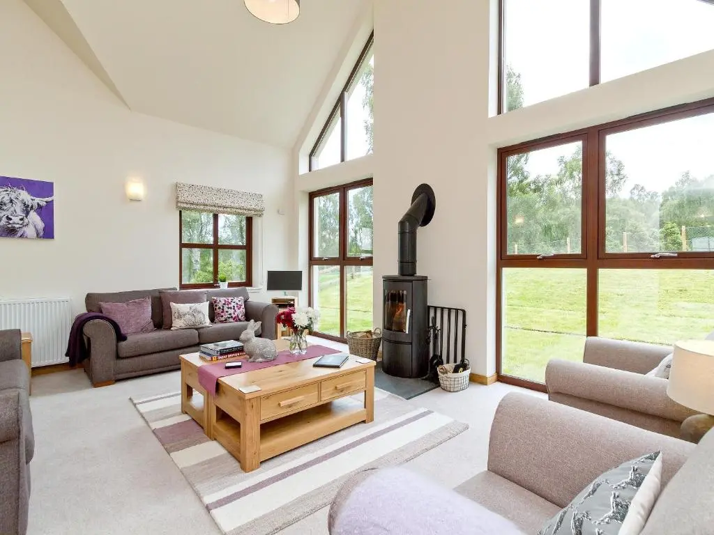 a living room with a couch and a table at Birch Corner in Aviemore