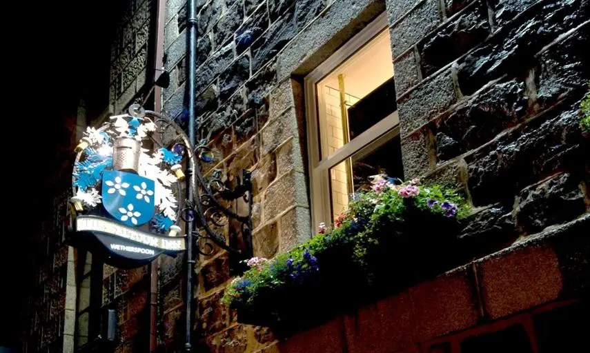 a window on a brick building with flowers on it at The Saltoun Inn in Fraserburgh