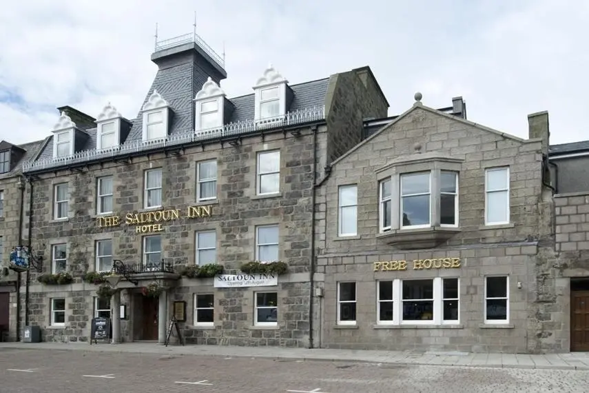 a stone building with a sign on the front of it at The Saltoun Inn in Fraserburgh