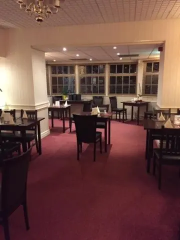 a restaurant with tables and chairs in a room at Alexandra Hotel in Ballater