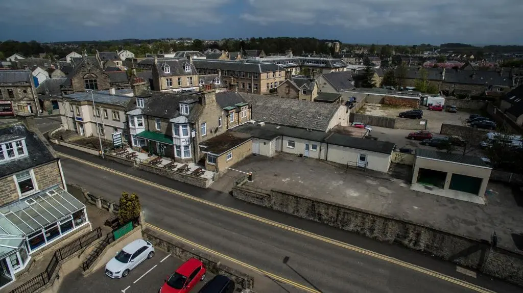 an aerial view of a city with cars parked on a street at Elgin City Centre Torr House hotel in Elgin