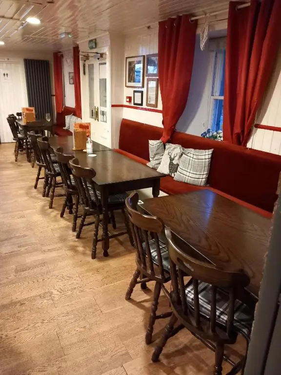 a row of tables and chairs in a restaurant at Aberdeen Arms Hotel Tarland in Tarland
