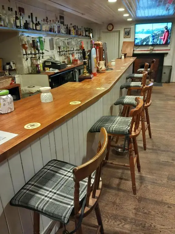 a row of chairs at a bar in a restaurant at Aberdeen Arms Hotel Tarland in Tarland