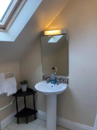 a bathroom with a sink and a mirror at Jacobite Rose in Inverness