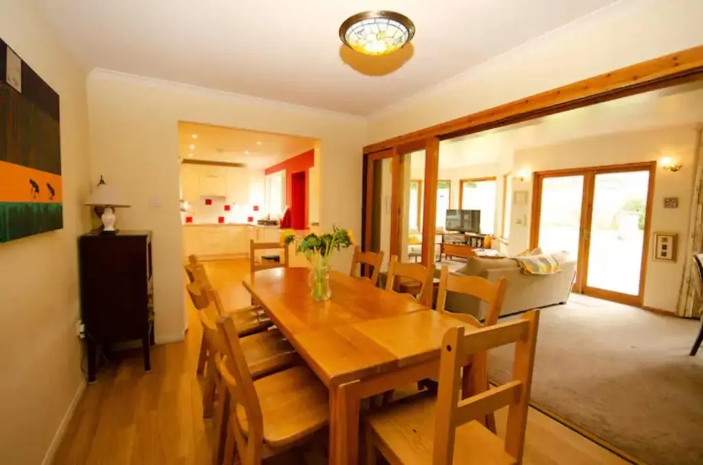 a dining room and living room with a table and chairs at Home Comforts in Peaceful 2 Acres in Inverness