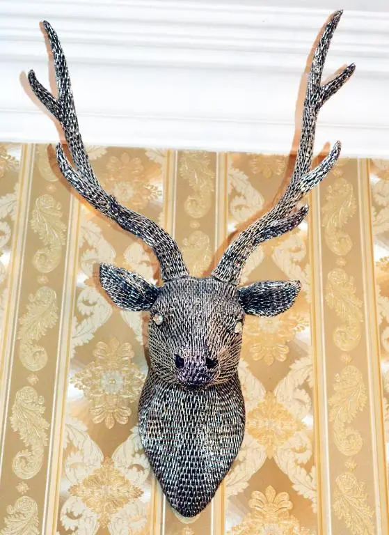 a statue of a deer head with antlers on a wall at Kintrae B&B in Buckie