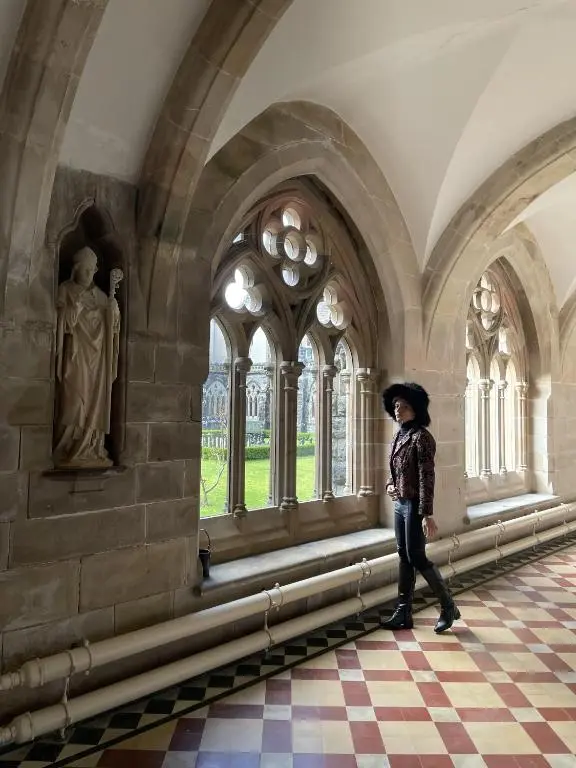 a woman is standing in a room in a building at The Classrooms, Loch Ness Abbey - 142m2 Lifestyle & Heritage apartment - Pool & Spa - The Highland Club - Resort on lake shores in Fort Augustus