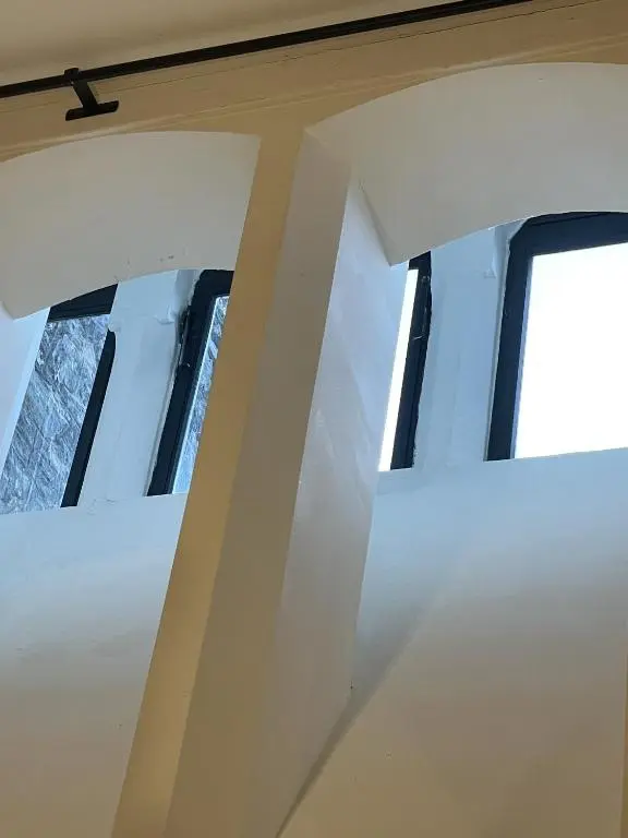 a group of windows in a room with white walls at The Classrooms, Loch Ness Abbey - 142m2 Lifestyle & Heritage apartment - Pool & Spa - The Highland Club - Resort on lake shores in Fort Augustus