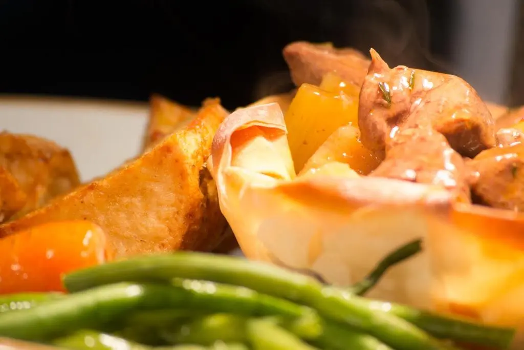 a plate of food with green beans and vegetables at The Balavil Hotel Newtonmore - Restaurant, Bars & Swimming Pool in Newtonmore