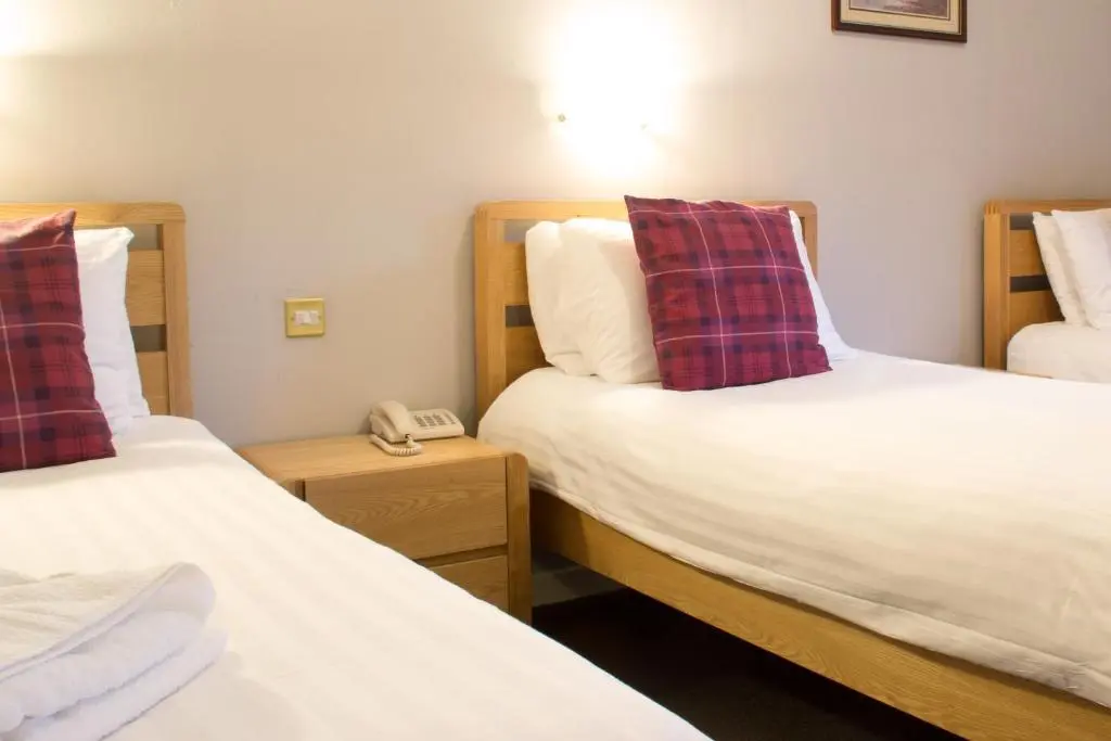 a hotel room with two beds and a telephone at The Balavil Hotel Newtonmore - Restaurant, Bars & Swimming Pool in Newtonmore