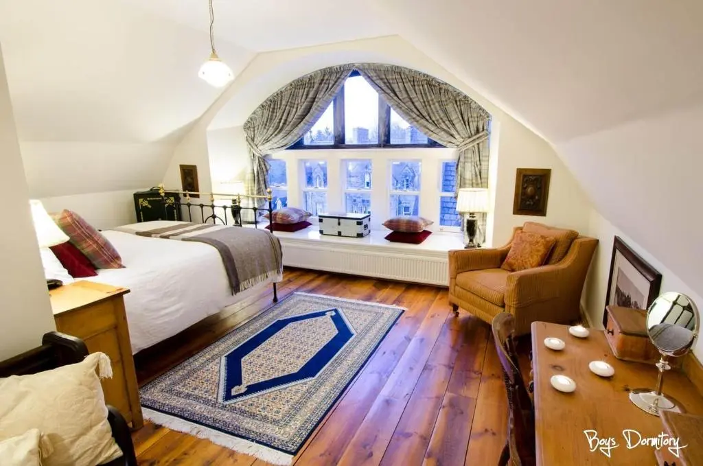 a bedroom with a bed and a large window at Boys Dormitory in Fort Augustus