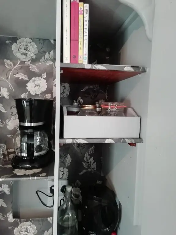 a cupboard filled with lots of items at Argyle Guest House in Tomintoul