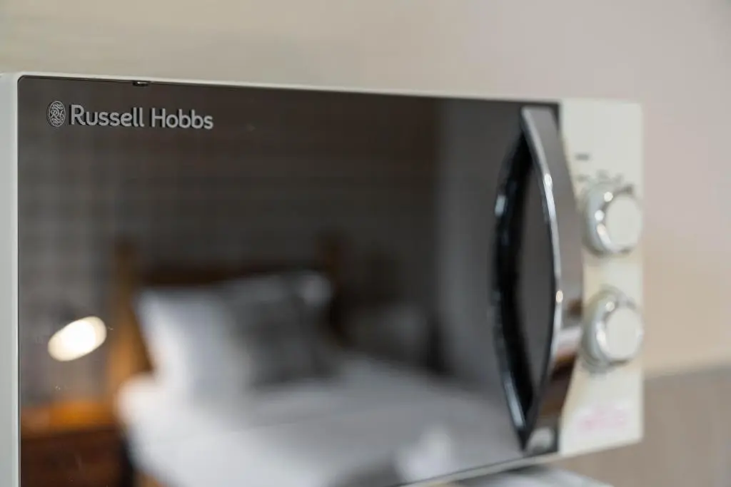 a microwave oven sitting on top of a counter at mySTAYINN Strathblane House in Inverness