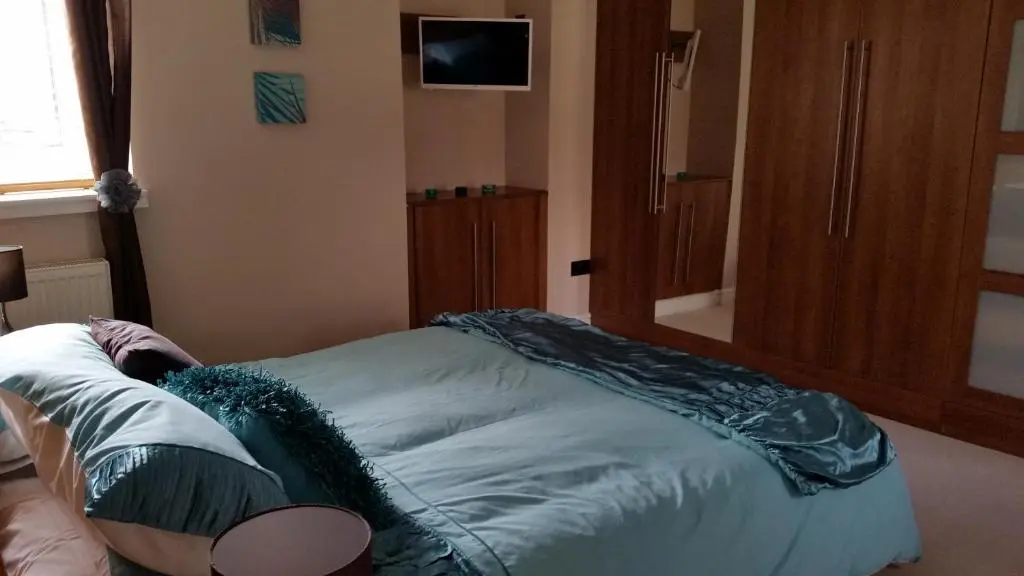 a small bed in a room with avertisementatronatronstrationbestosbestosbestosbestos at Nairnia in Nairn