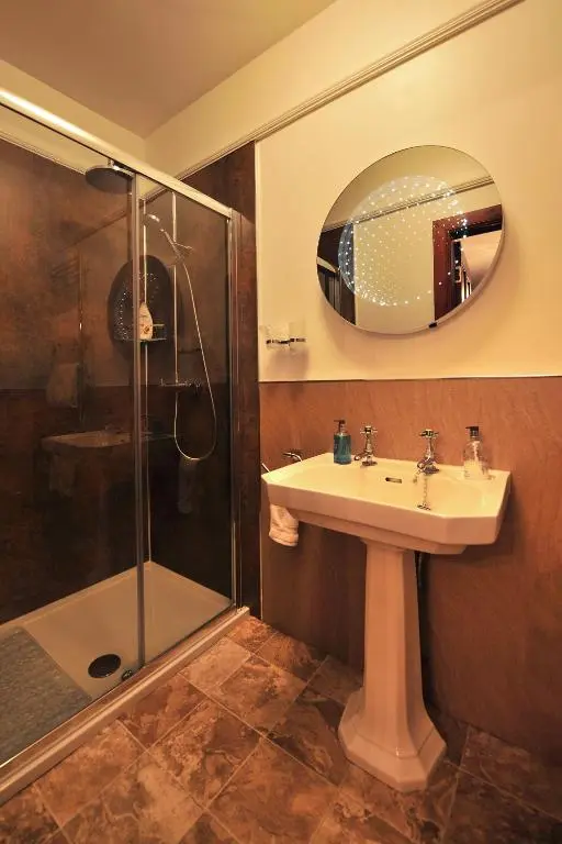 a bathroom with a sink and a shower at St Michaels Guest House in Elgin