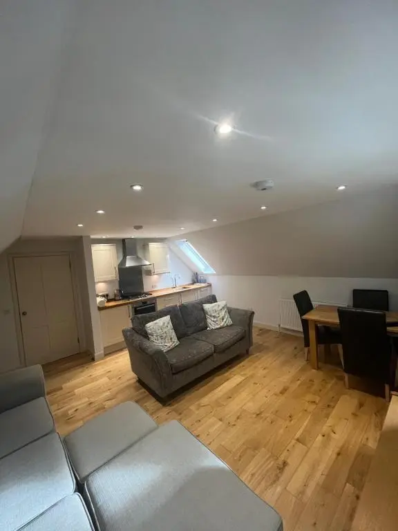 a living room with a couch and a table at Wee Corsee in Nairn