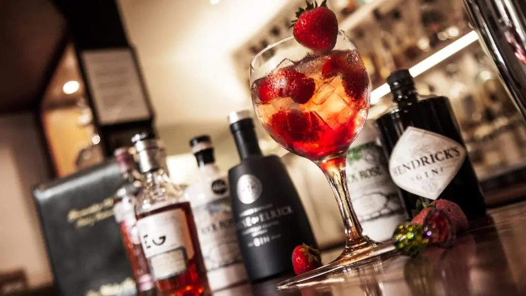 a martini glass with fruit in it on a bar at Glenmoriston Arms Hotel in Invermoriston
