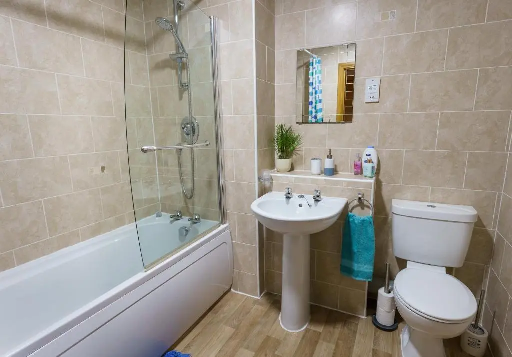 a bathroom with a toilet and a sink and a shower at Lossiemouth Haven in Lossiemouth