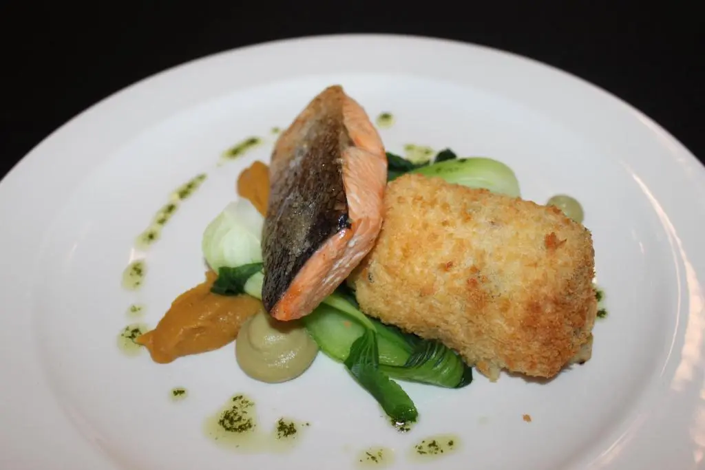 a plate of food with a piece of fish and vegetables at Mackays Hotel in Wick