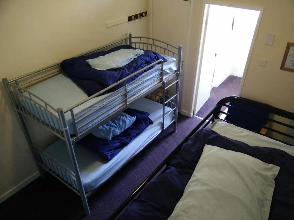 a room with two bunk beds in a room at The Smugglers Hostel in Tomintoul