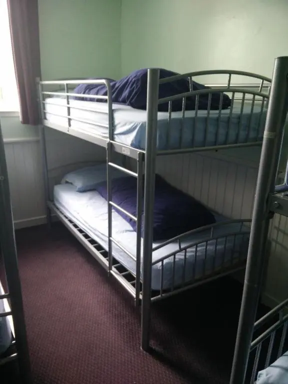a couple of bunk beds in a room at The Smugglers Hostel in Tomintoul