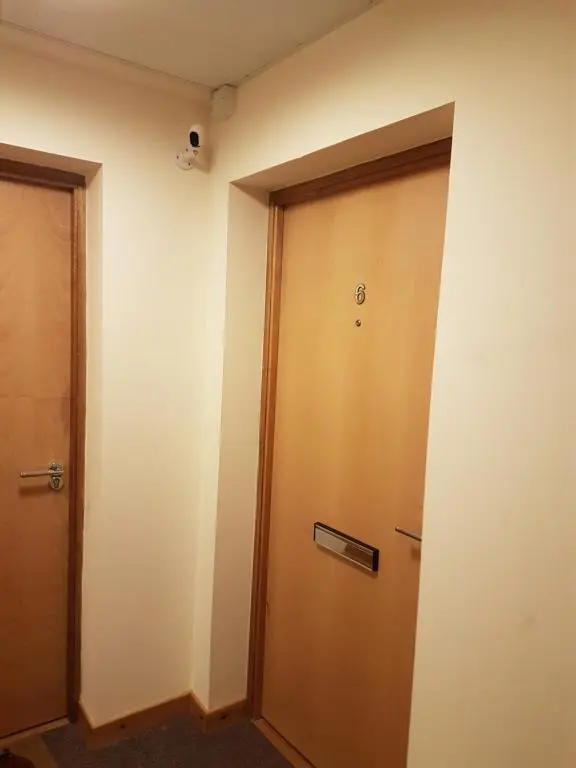 a wooden door in a room with a wall at Lascala City Apartment in Inverness