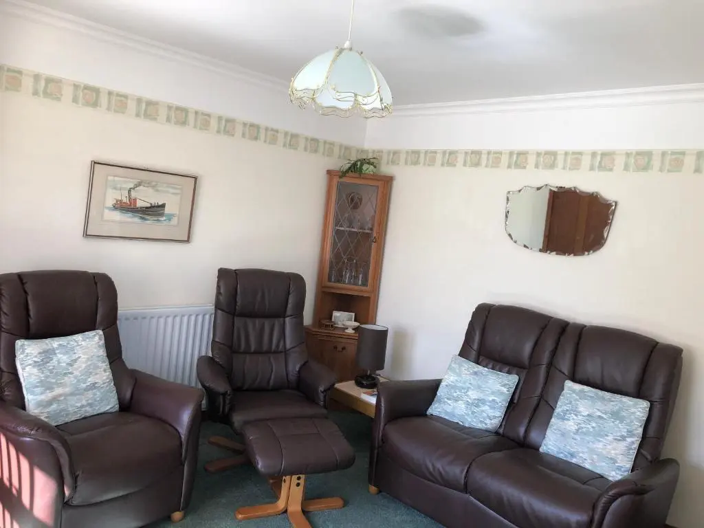 a living room with two chairs and a couch at Belvedere Holiday Home in Whitehills