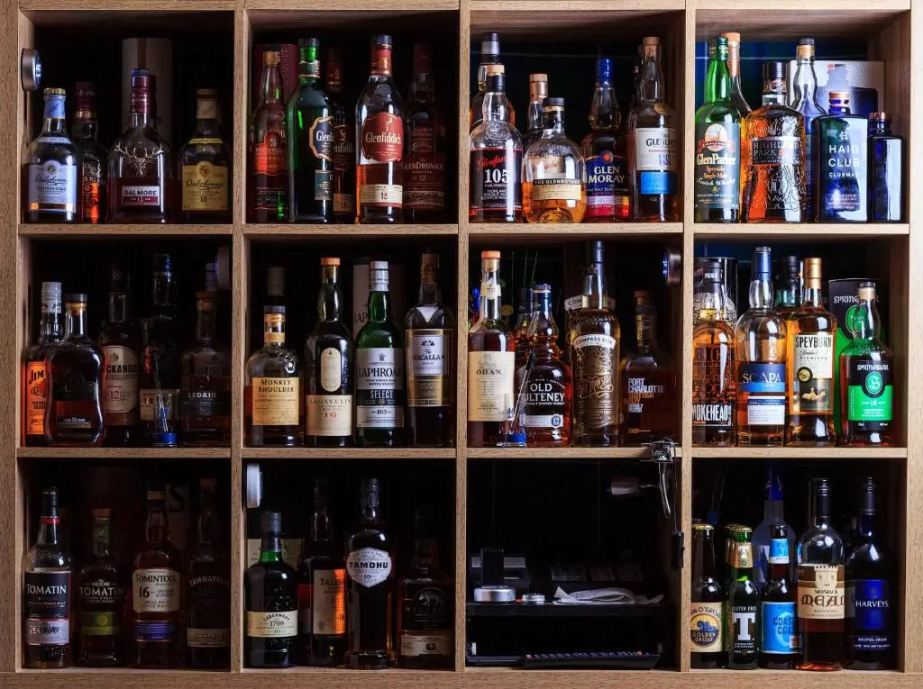 a cabinet filled with lots of bottles of alcohol at Bannockburn Inn in Helmsdale