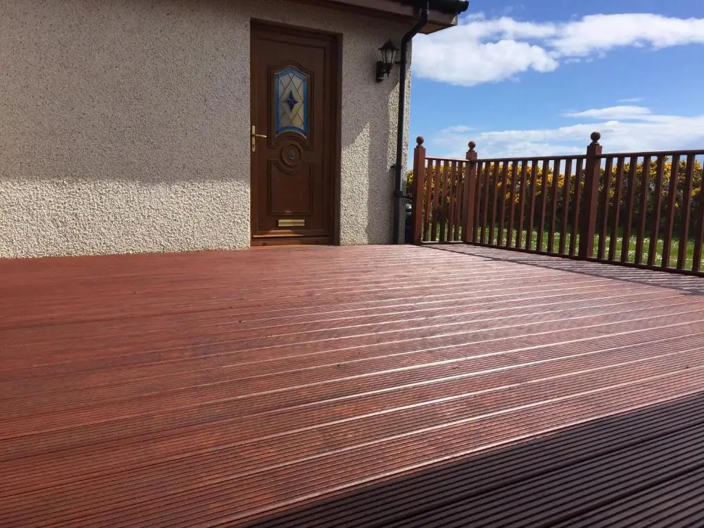 a wooden deck with a door and a fence at Acarsaid B&B in Lybster