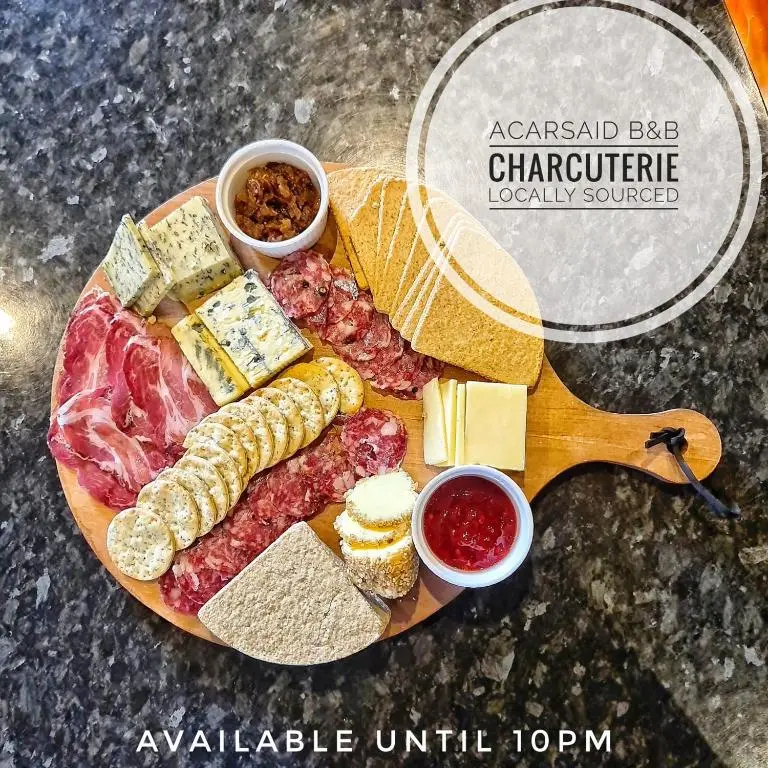 a plate of food with meats cheese and other foods at Acarsaid B&B in Lybster