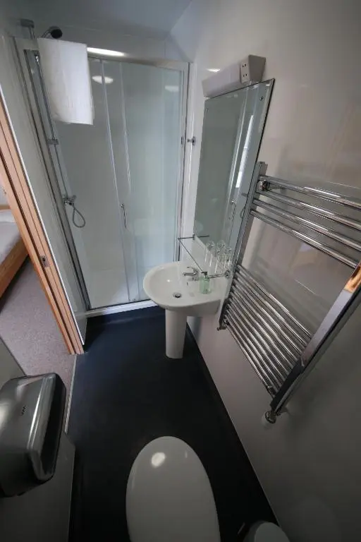 a bathroom with a toilet and a sink at Black Isle Bar & Rooms in Inverness