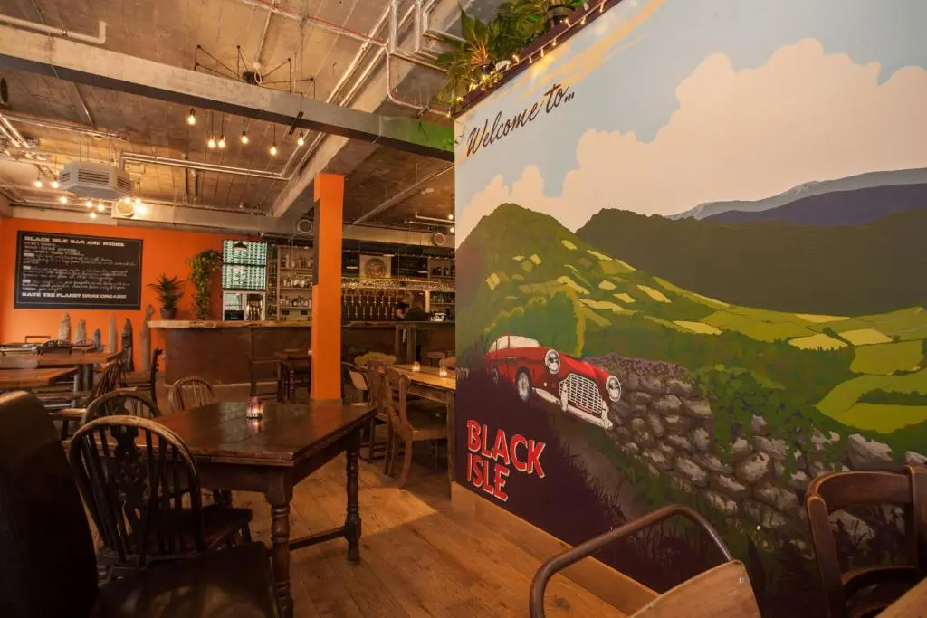 a restaurant with a mural of a train on the wall at Black Isle Bar & Rooms in Inverness
