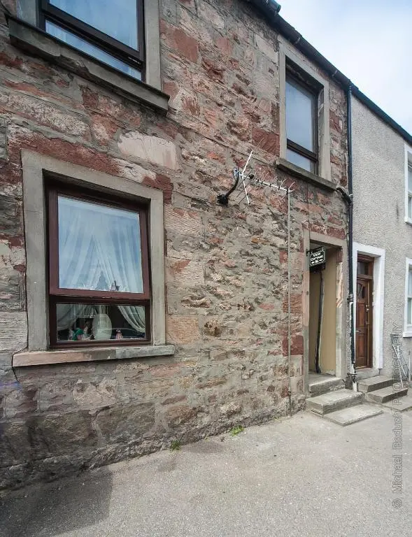 a brick building with a window on the side of it at Cosy Ness Escape, 16B Ardconnel Street in Inverness