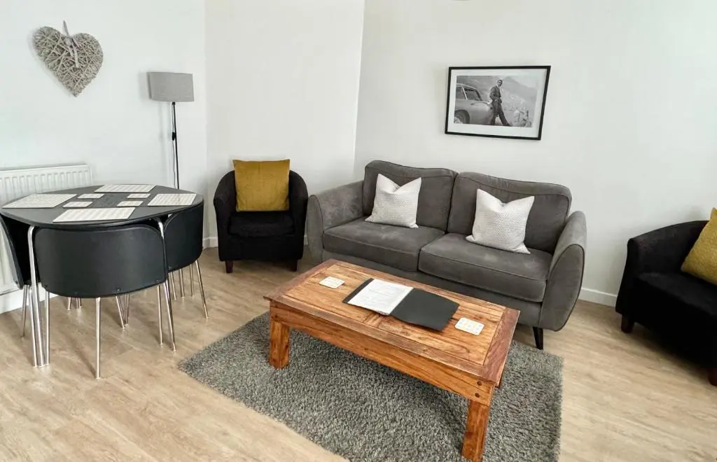 a living room with a couch and a table at City Centre Cottage in Inverness