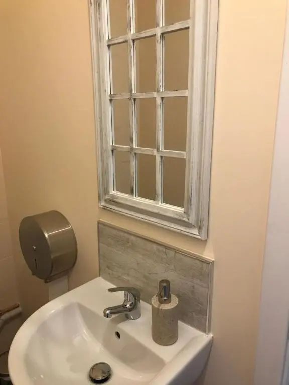a bathroom with a sink and a window at Loch Ness Backpackers Lodge in Drumnadrochit
