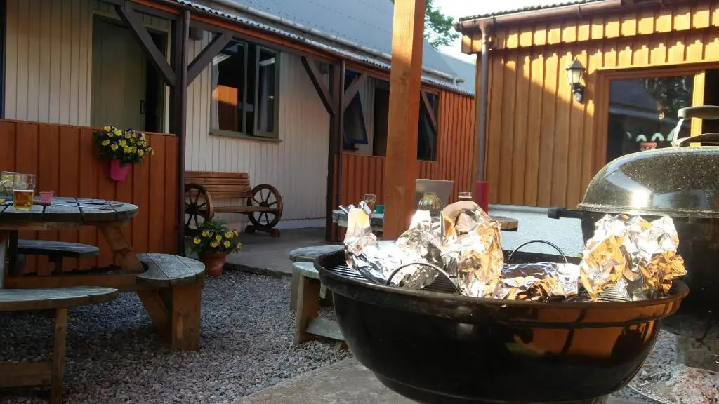 a fire hydrant in a yard next to a patio at Loch Ness Backpackers Lodge in Drumnadrochit