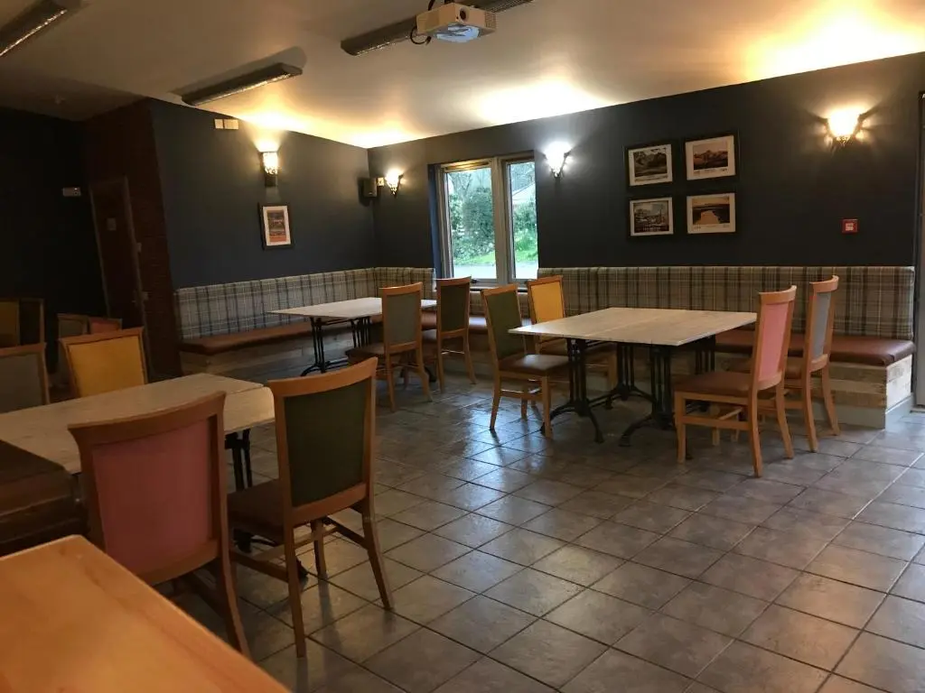 a restaurant dining room with tables and chairs at Loch Ness Backpackers Lodge in Drumnadrochit