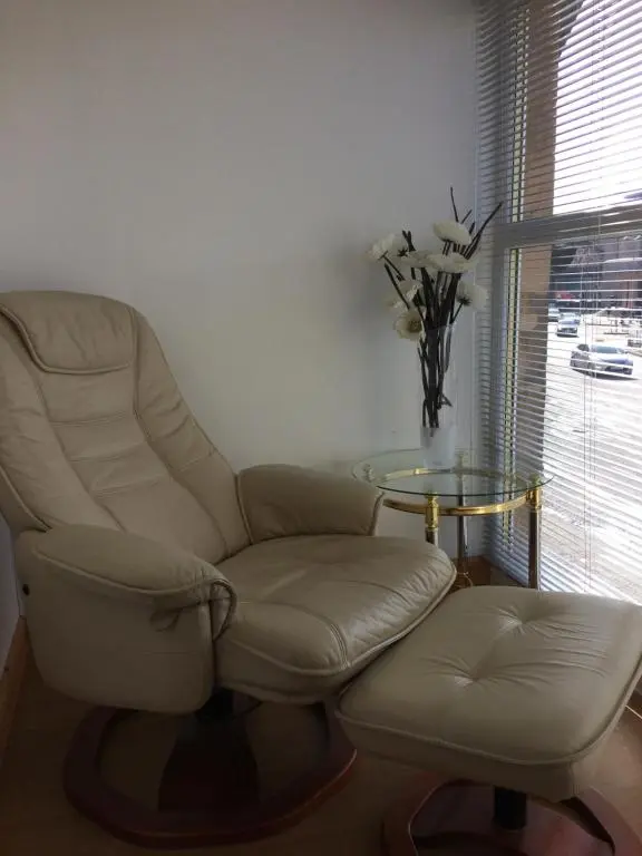 a living room with a chair and a table at Eastgate Apartment in Inverness