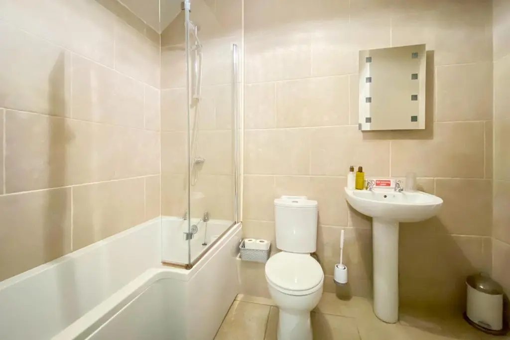 a bathroom with a toilet and a sink and a shower at Strathardle Lodge in Kirkmichael