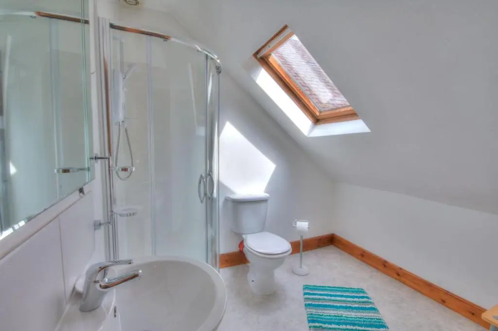 a bathroom with a toilet and a shower and a sink at Glasdair in Inverness