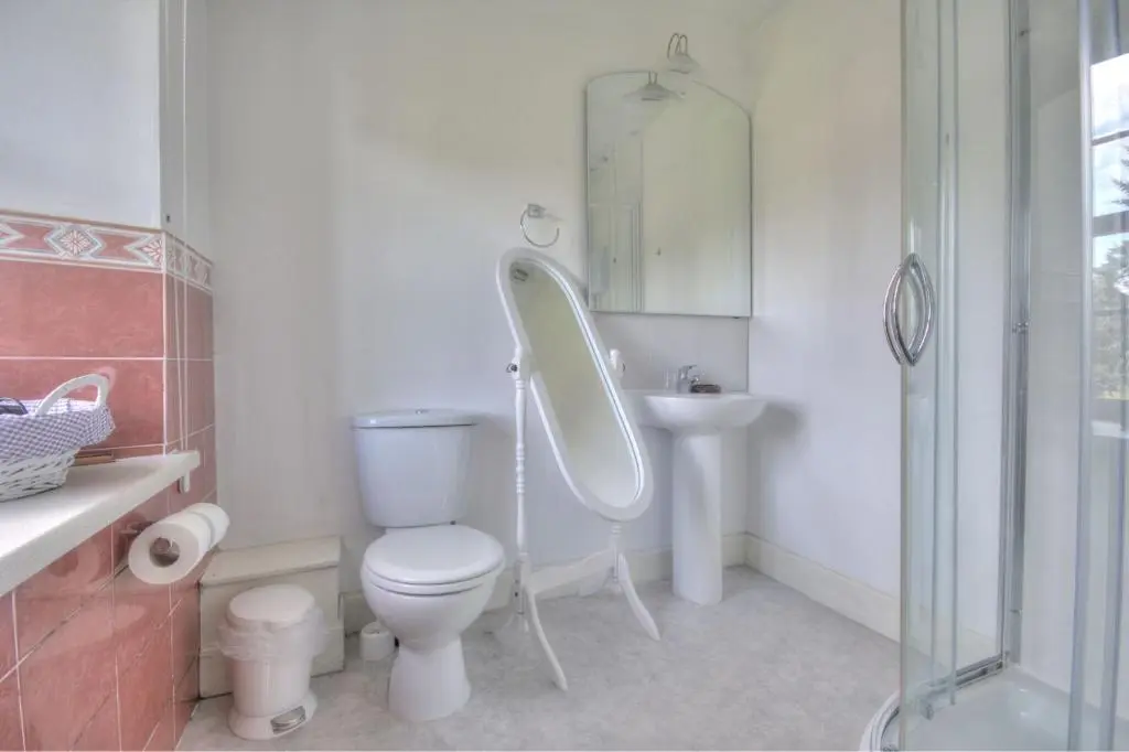 a bathroom with a shower and a toilet and a sink at Glasdair in Inverness