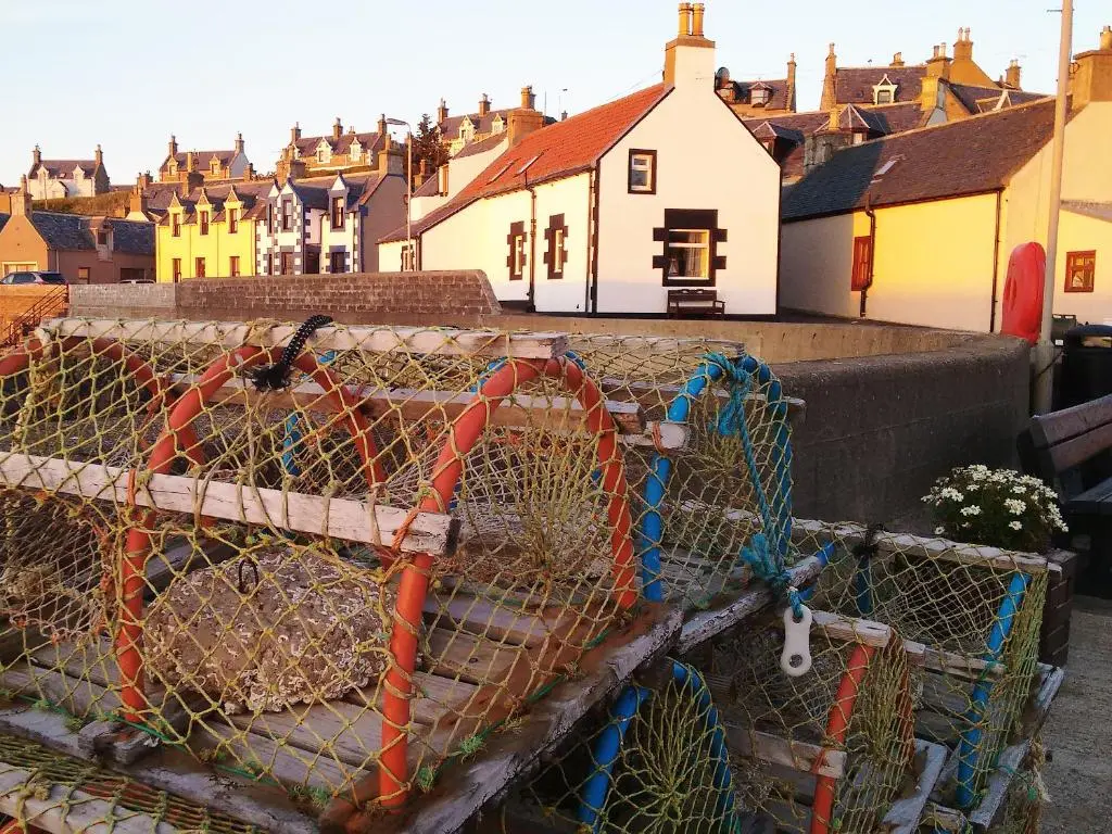 a cage full of hay on top of a house at Salty Dog in Findochty
