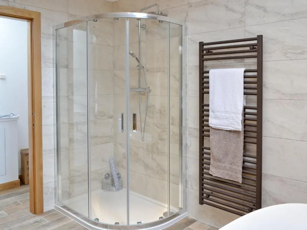 a shower with a glass enclosure in a bathroom at Longcroft Dairy in Oyne