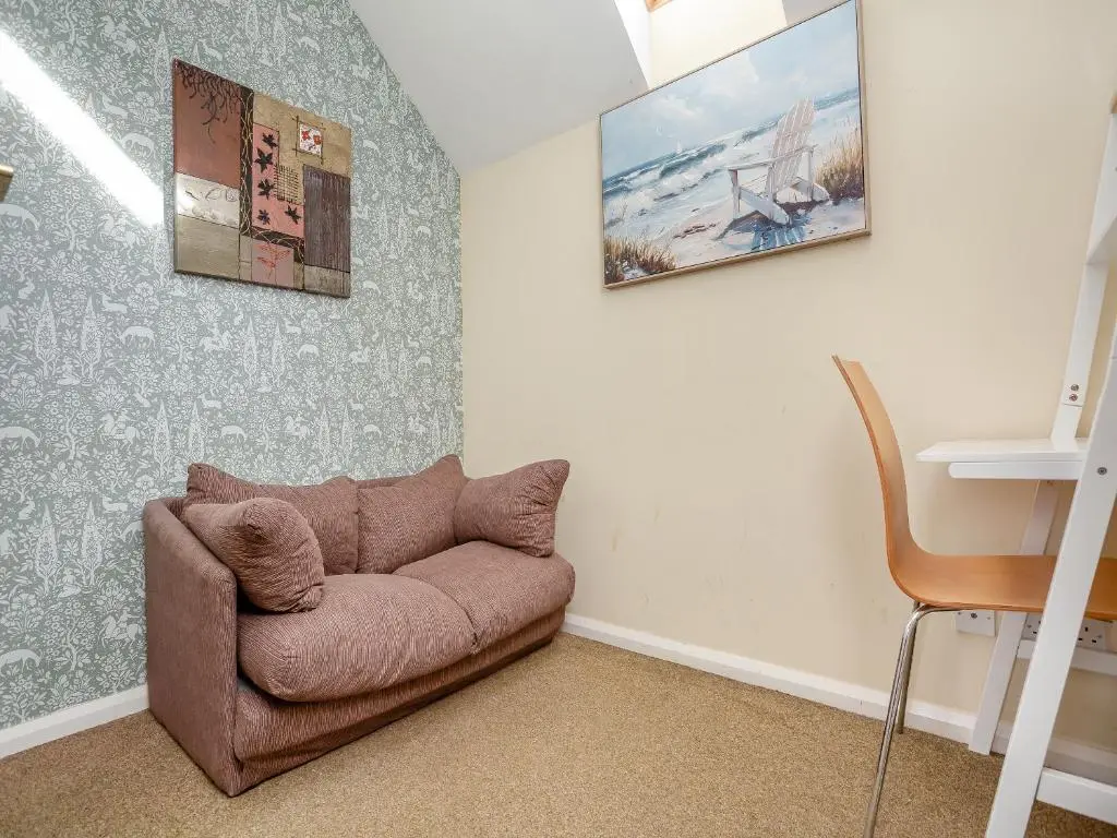 a living room with a brown couch in a room at Cairnie View in Aviemore