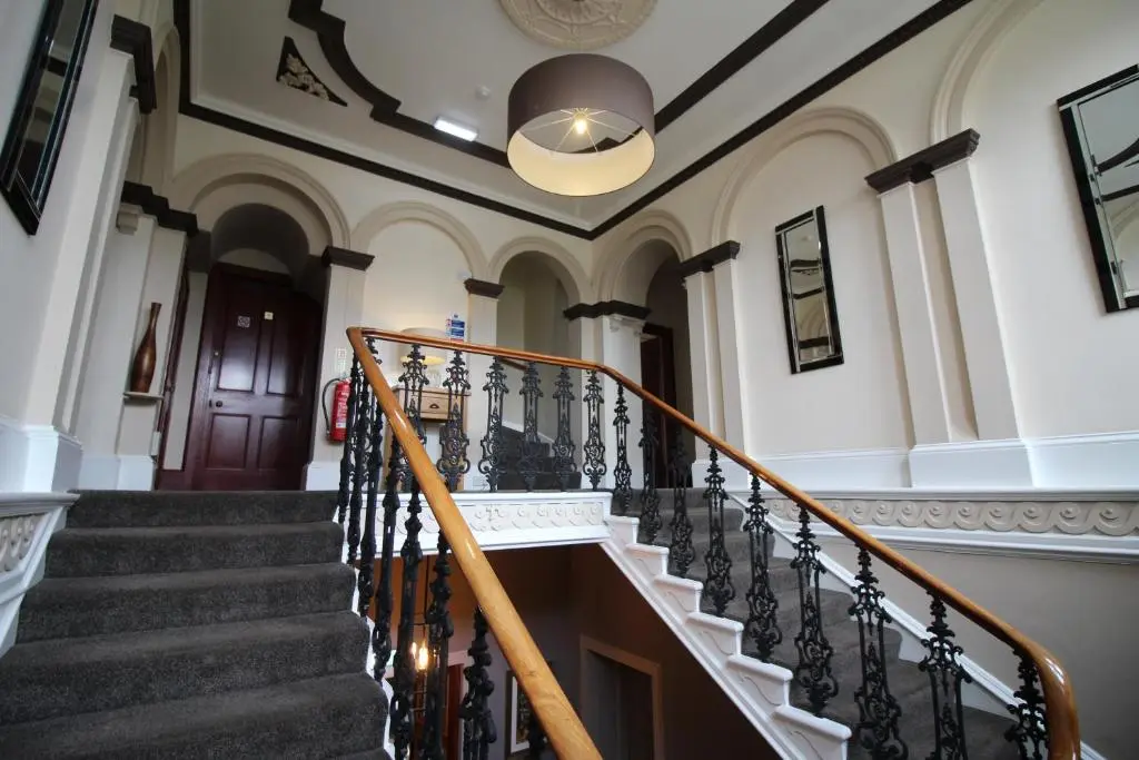 a winding staircase in a building with a ceiling at The Royal Hotel Elgin in Elgin