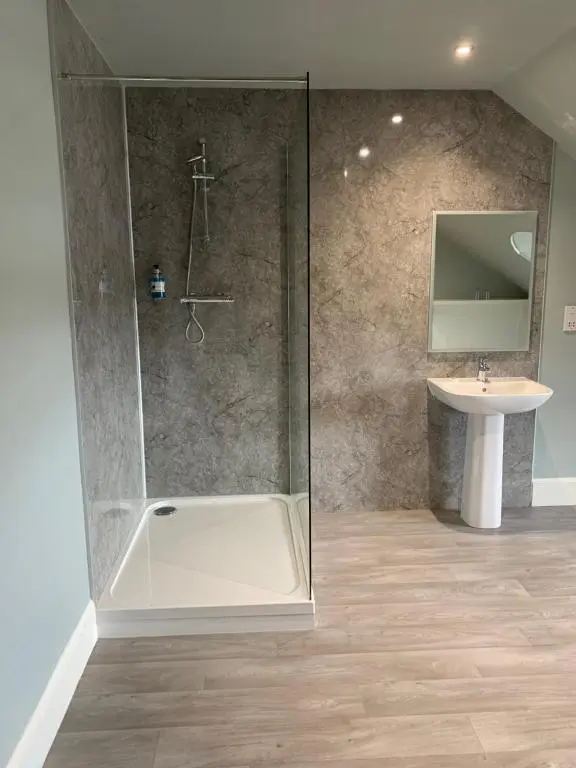 a bathroom with a shower and a sink at The Royal Hotel Elgin in Elgin