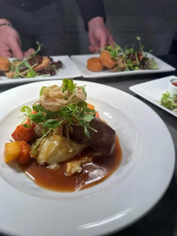 a white plate of food on a table at The Royal Hotel Elgin in Elgin